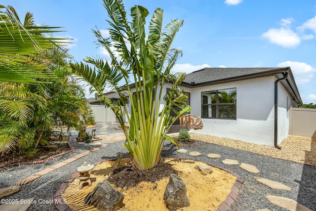 413 Catfish Pl, Cocoa, FL 32927 - exterior space with fence, a shingled roof, stucco siding, and a patio area