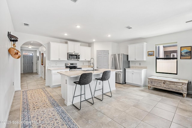 413 Catfish Pl, Cocoa, FL 32927 - kitchen with visible vents, arched walkways, a sink, light countertops, and stainless steel appliances