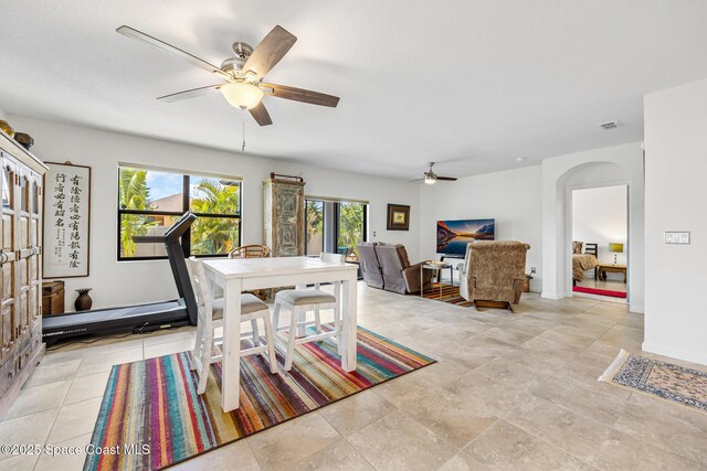 413 Catfish Pl, Cocoa, FL 32927 - dining area featuring visible vents, a ceiling fan, arched walkways, and a wealth of natural light