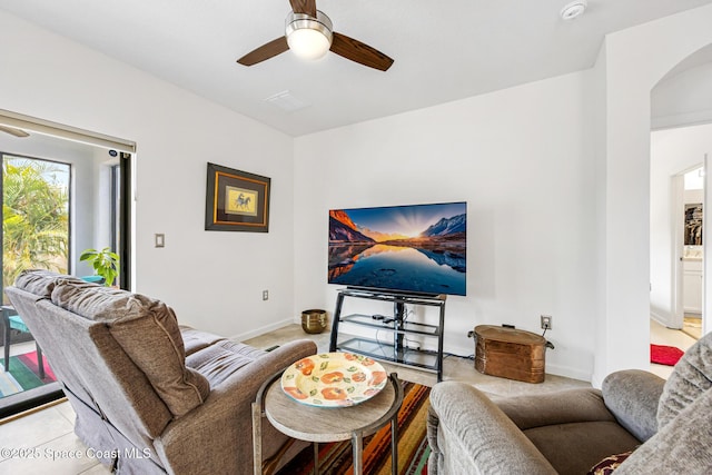 413 Catfish Pl, Cocoa, FL 32927 - living room with arched walkways, ceiling fan, light colored carpet, and baseboards
