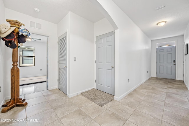 413 Catfish Pl, Cocoa, FL 32927 - foyer with light tile patterned floors, arched walkways, baseboards, and visible vents