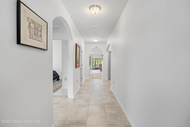 413 Catfish Pl, Cocoa, FL 32927 - corridor featuring light tile patterned floors, arched walkways, baseboards, and visible vents