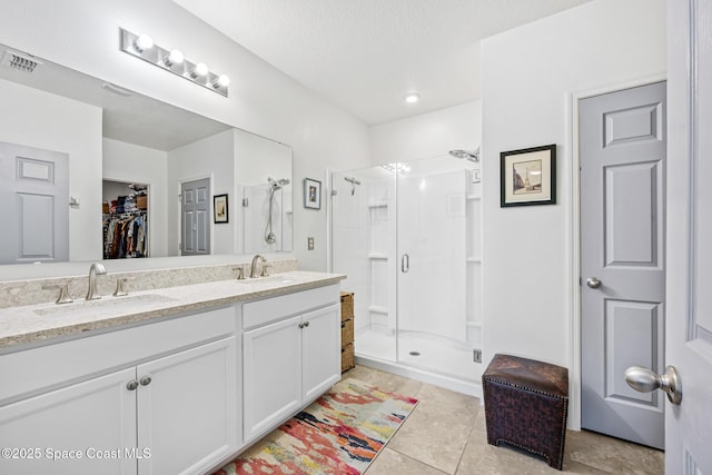 413 Catfish Pl, Cocoa, FL 32927 - full bathroom with double vanity, visible vents, a shower stall, and a sink