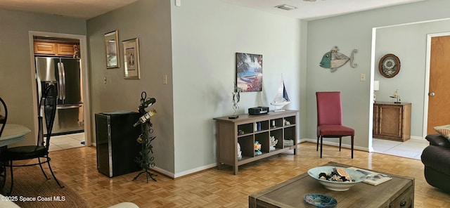 living area featuring visible vents and baseboards