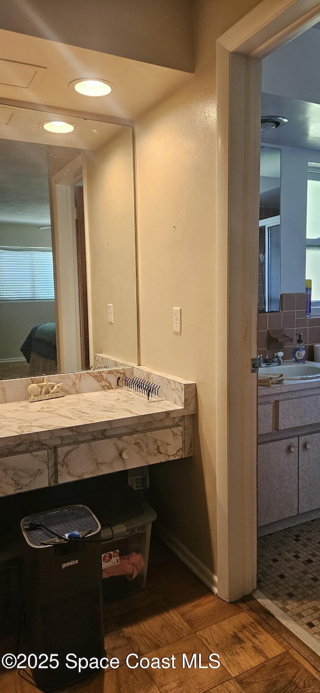 bathroom featuring connected bathroom, vanity, and decorative backsplash