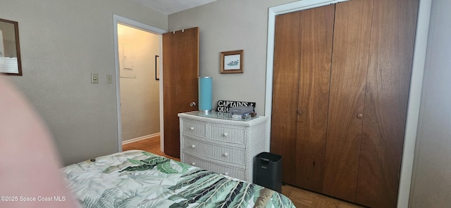 bedroom with a closet and baseboards