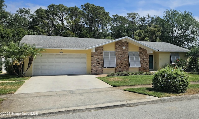 ranch-style house with a front yard, concrete driveway, a garage, and brick siding