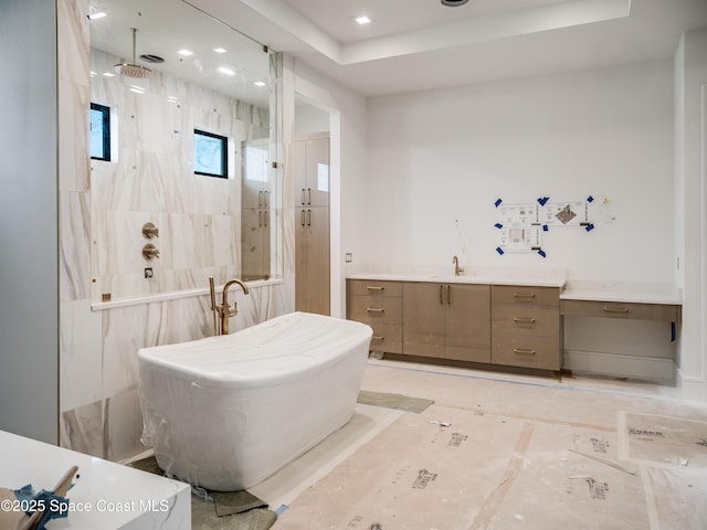 3717 Upper Floridian Way, Rockledge, FL 32955 - full bathroom with a marble finish shower, a freestanding tub, a tray ceiling, and vanity