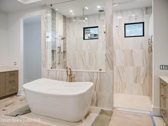 3717 Upper Floridian Way, Rockledge, FL 32955 - bathroom with vanity, a freestanding bath, and a marble finish shower