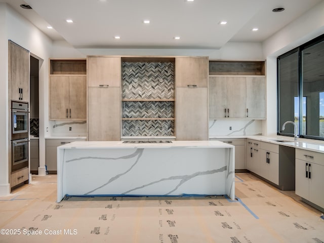 3717 Upper Floridian Way, Rockledge, FL 32955 - kitchen with open shelves, stainless steel double oven, a sink, a center island, and light stone counters