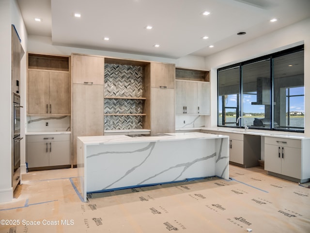 3717 Upper Floridian Way, Rockledge, FL 32955 - kitchen featuring open shelves, a kitchen island, light stone countertops, double oven, and recessed lighting