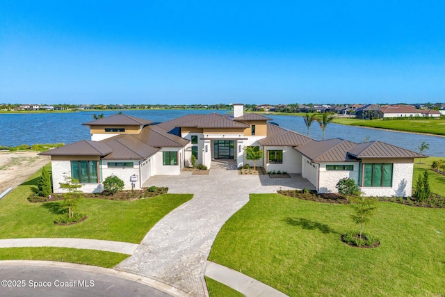 3717 Upper Floridian Way, Rockledge, FL 32955 - view of front facade featuring a standing seam roof, metal roof, and a water view