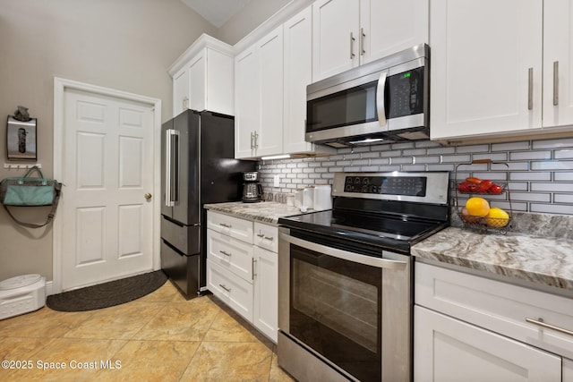 2544 Ventura Cir, Melbourne, FL 32904 - kitchen with stainless steel appliances, light stone countertops, white cabinets, and decorative backsplash