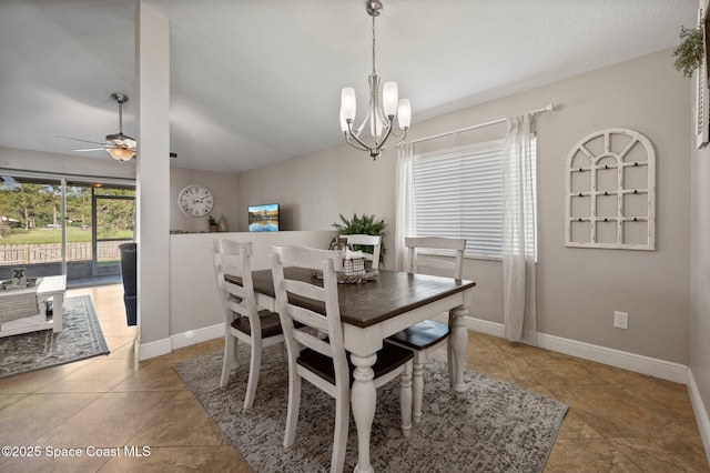 2544 Ventura Cir, Melbourne, FL 32904 - dining space featuring ceiling fan with notable chandelier, light tile patterned flooring, and baseboards