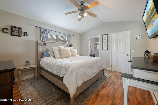2544 Ventura Cir, Melbourne, FL 32904 - bedroom featuring wood finished floors, ensuite bathroom, baseboards, and vaulted ceiling