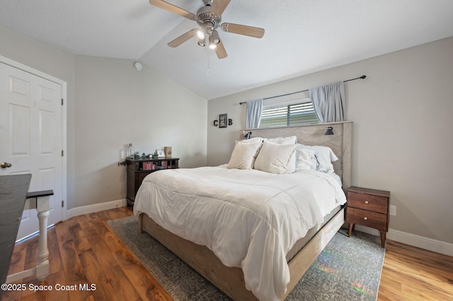 2544 Ventura Cir, Melbourne, FL 32904 - bedroom with baseboards, ceiling fan, wood finished floors, and lofted ceiling