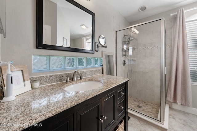 2544 Ventura Cir, Melbourne, FL 32904 - bathroom with a shower stall, plenty of natural light, vanity, and tile patterned floors