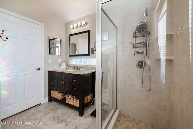 2544 Ventura Cir, Melbourne, FL 32904 - bathroom featuring a tile shower, tile patterned floors, vanity, and a wealth of natural light