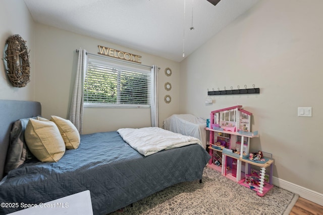 2544 Ventura Cir, Melbourne, FL 32904 - bedroom featuring wood finished floors, baseboards, and vaulted ceiling
