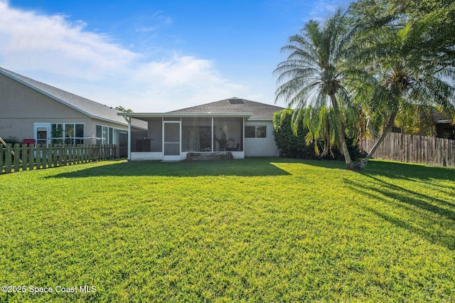 2544 Ventura Cir, Melbourne, FL 32904 - back of house with a yard, a fenced backyard, a sunroom, and stucco siding