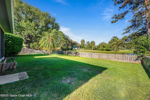 2544 Ventura Cir, Melbourne, FL 32904 - view of yard with a fenced backyard and a water view