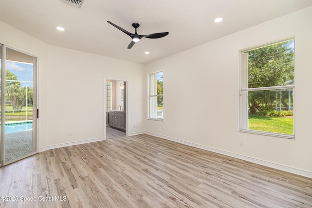 unfurnished room with light wood-style flooring, ceiling fan, baseboards, and recessed lighting