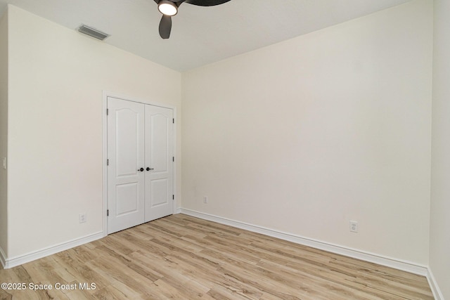 empty room featuring light wood-style floors, ceiling fan, and baseboards