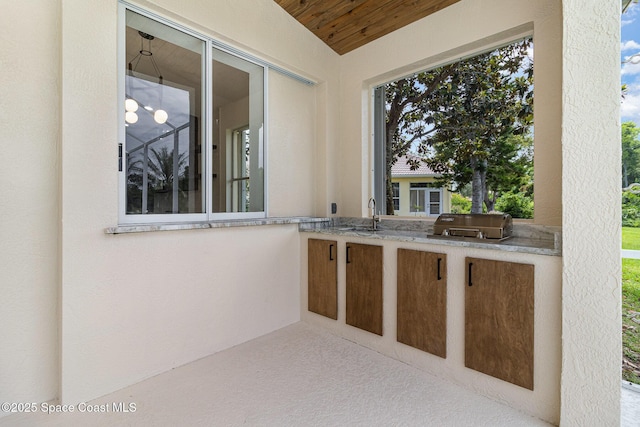 view of patio featuring an outdoor kitchen and a sink