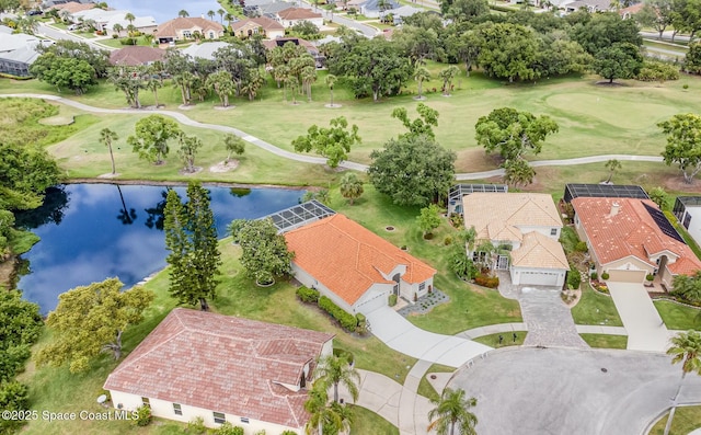aerial perspective of suburban area featuring a large body of water and a golf course