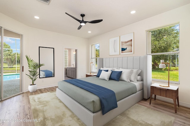 bedroom with access to outside, light wood-style flooring, baseboards, ensuite bathroom, and recessed lighting