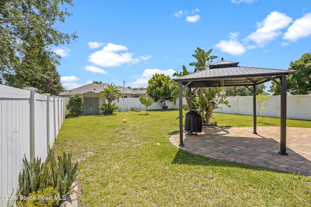 view of yard with a fenced backyard, a gazebo, and a patio