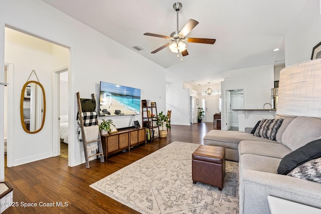 living area with ceiling fan, vaulted ceiling, visible vents, baseboards, and dark wood-style flooring