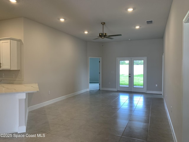 unfurnished living room with baseboards, recessed lighting, ceiling fan, and french doors
