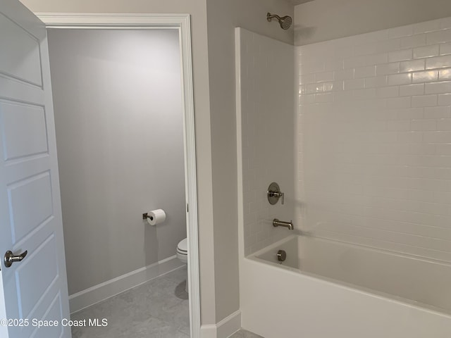 bathroom with baseboards, tile patterned flooring, shower / bath combination, and toilet