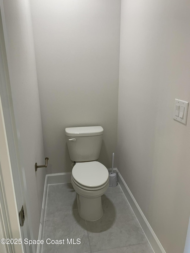 bathroom with baseboards and toilet