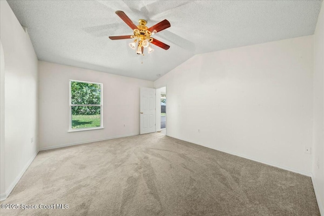 unfurnished room featuring a ceiling fan, vaulted ceiling, and carpet floors