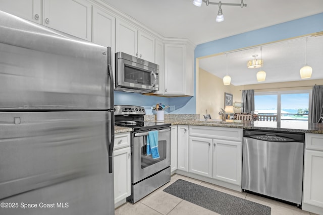 3150 N Harbor City Blvd Unit 236, Melbourne, FL 32935 - kitchen with light tile patterned floors, white cabinetry, stone countertops, appliances with stainless steel finishes, and a sink