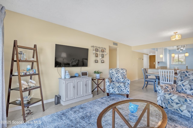 3150 N Harbor City Blvd Unit 236, Melbourne, FL 32935 - living room with visible vents, baseboards, and light tile patterned floors