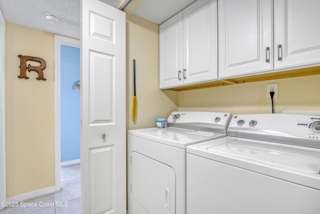 3150 N Harbor City Blvd Unit 236, Melbourne, FL 32935 - laundry area with washer and dryer, light tile patterned floors, baseboards, and cabinet space