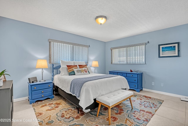 3150 N Harbor City Blvd Unit 236, Melbourne, FL 32935 - bedroom featuring a textured ceiling, light tile patterned floors, and baseboards