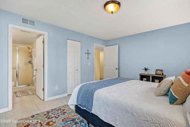 3150 N Harbor City Blvd Unit 236, Melbourne, FL 32935 - bedroom with light tile patterned floors, connected bathroom, a closet, visible vents, and baseboards