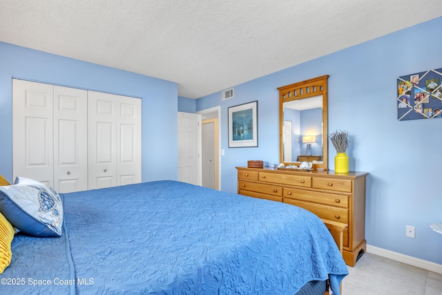 3150 N Harbor City Blvd Unit 236, Melbourne, FL 32935 - bedroom with a closet, baseboards, visible vents, and a textured ceiling