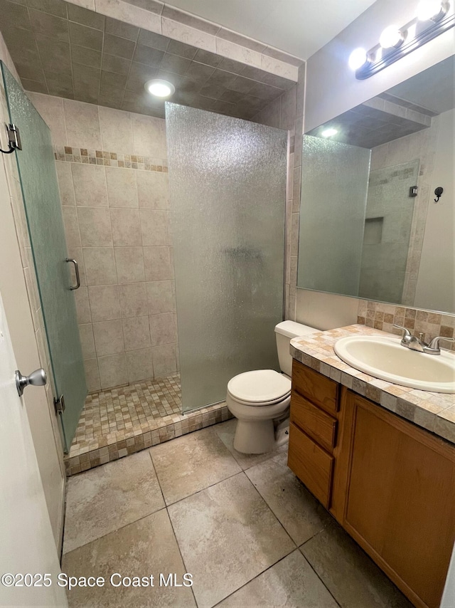 full bath with a shower stall, toilet, and vanity