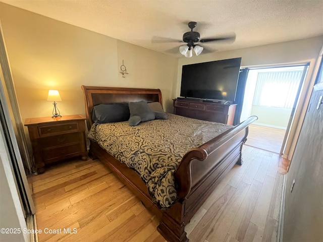 bedroom featuring ceiling fan, a textured ceiling, and light wood-type flooring