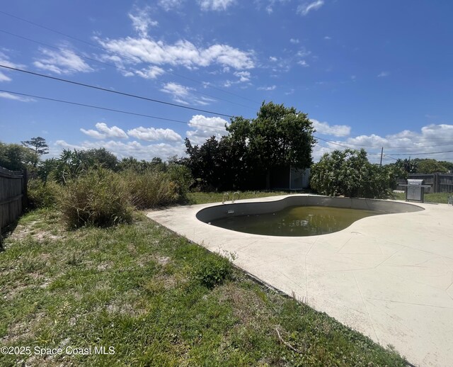 view of community with a pool and fence