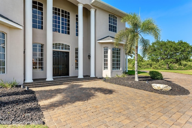 property entrance featuring stucco siding