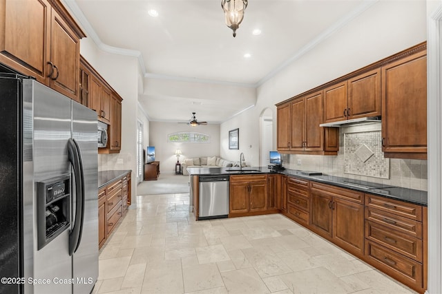kitchen with stainless steel appliances, dark countertops, open floor plan, tasteful backsplash, and brown cabinetry