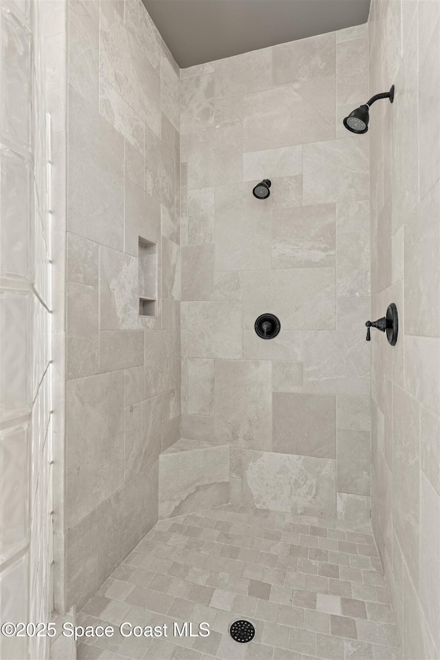 bathroom with tiled shower