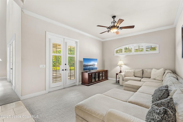 living area featuring french doors, light colored carpet, healthy amount of natural light, ornamental molding, and a ceiling fan