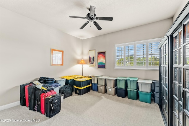 recreation room featuring carpet flooring, ceiling fan, and baseboards